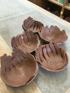 four chocolate baseball mitts sitting on top of a counter