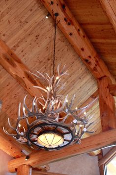 a chandelier with antlers hanging from the ceiling