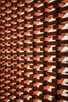 a wall made out of wooden planks in front of a building