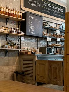 the inside of a bakery with lots of items on shelves and counter space for customers