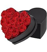 a heart shaped box filled with red roses