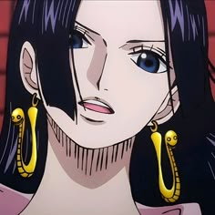 a woman with blue eyes and long black hair wearing large gold earring's