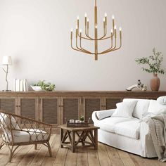 a living room filled with furniture and a chandelier hanging over the top of it