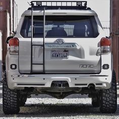 the rear end of a white toyota truck