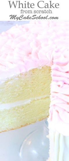 a white cake with pink frosting sitting on top of a plate