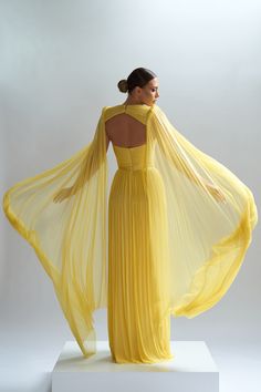 The Enyo cape is a fluid masterpiece, capturing light and elegance in its flowing pleats with vibrant color.    Cape made of pure silk tulle, silk satin lining for extra comfort   Closing system: buttons    Dry clean     The price shown includes the cape only; the dress, code CA72, can be purchased separately   Shown color: Yellow  Made In EU Pleated Tulle Dress, Tulle Cocktail Dress, Tulle Cape, Corset Skirt, Tulle Evening Dress, Designer Evening Gowns, Silk Tulle, Womens Prom Dresses, Luxury Wear