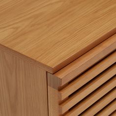 a close up of a wooden cabinet with slats on the top and bottom part