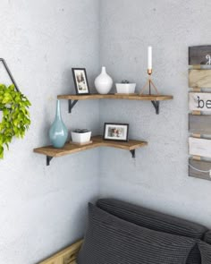 two shelves with pictures, vases and other items on them in the corner of a room