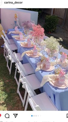 a table set up with pink and blue decorations