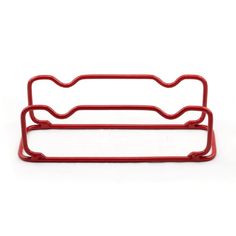 a red metal rack with two handles on top of each other, against a white background