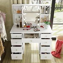 a white dressing table with drawers and lights