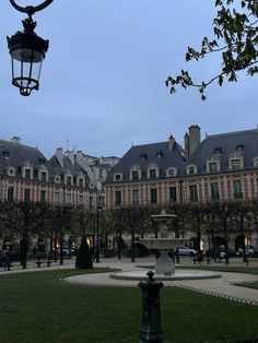 a large building with a fountain in front of it