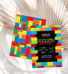 a lego themed birthday party is set up on a white plate with paper fans in the background