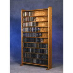 an oak bookcase with dvd's on the shelves and dvds in each shelf