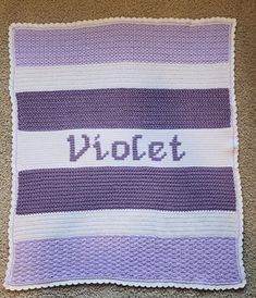 a crocheted blanket with the word violett written on it in white and purple