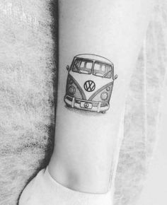 a black and white photo of a vw bus tattoo on the left inner arm