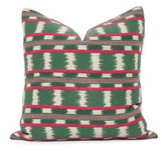 a green and red pillow on a white background