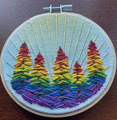 an embroidery project with colorful trees on it