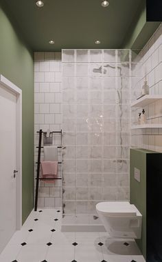 a white toilet sitting next to a shower in a bathroom under two light bulbs on the ceiling