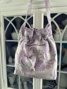 a handbag hanging from the side of a china cabinet