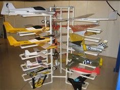 there are many model airplanes on display in this room, including one that is upside down