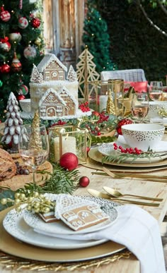 a table set for christmas with plates and silverware