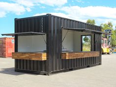 a large black container sitting in the middle of a parking lot