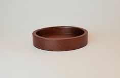 a brown ring sitting on top of a white table