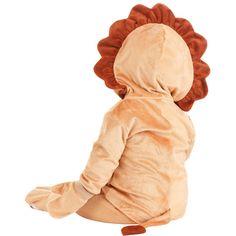 a small child in a lion costume sitting on the ground with its back turned to the camera