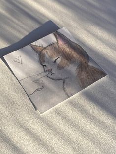 a drawing of a cat with a heart on it's forehead and eyes closed