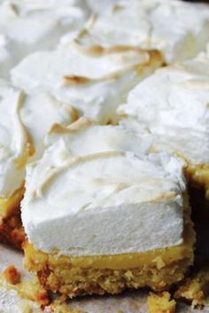 a cake with white frosting sitting on top of a table