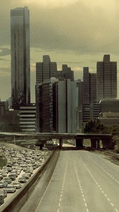 a highway filled with lots of traffic in front of tall buildings and high rise buildings