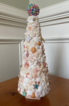 a christmas tree made out of seashells on a table