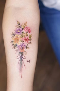 a woman's arm with flowers on it