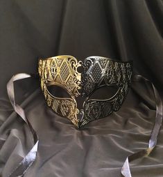 This men's luxury Masquerade mask is painted in a two-tone gold and black color. Then mask has a unique design and is made out of a lightweight metal. Mask has some flex and has a smooth comfortable fit. Stand out at your next Masquerade ball or Venetian mask party with this unique mask!  Color: gold and black. Black And Gold Masquerade Mask, Gold Masquerade Mask, Masquerade Prom, Luxury Mask, Mens Masquerade Mask, Masquerade Ball Mask, Masquerade Wedding