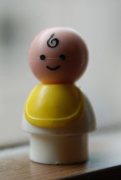 a small toy with a smiley face on it