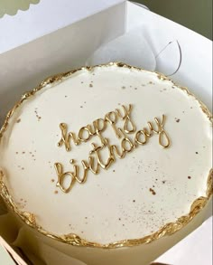 a birthday cake with the words happy birthday written on it in gold foil and frosting