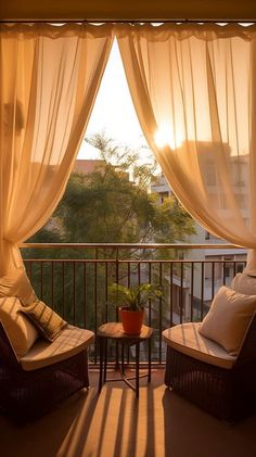 two wicker chairs sitting on top of a balcony next to a table with a potted plant