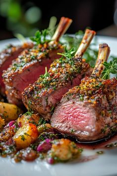 two pieces of meat on a plate with potatoes and garnishes next to it