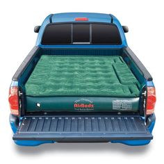 the back end of a blue truck with an inflatable bed