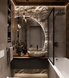 a modern bathroom with stone walls and flooring