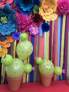 colorful paper flowers and fake cactuses are on display