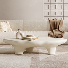 a white coffee table sitting on top of a carpeted floor next to a couch