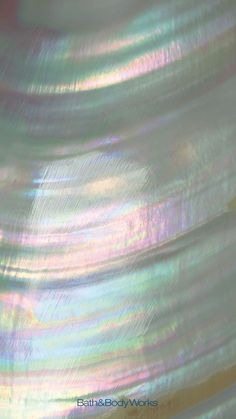 the back side of a white plastic object with iridescent colors and lines on it