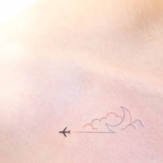 an airplane is flying through the sky on top of a woman's stomach