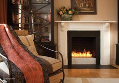 a living room filled with furniture and a fire place in the middle of the room