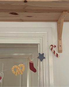 christmas decorations hanging from the ceiling above a door way with candy canes and pretzels