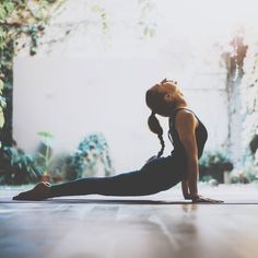 a woman is doing yoga on the floor