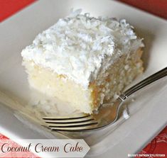 a piece of coconut cream cake sitting on top of a white plate with a fork