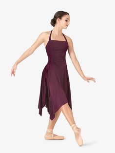 a woman in a purple dress is dancing